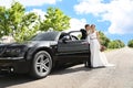 Happy bride and groom near car Royalty Free Stock Photo