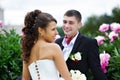 Happy bride and groom near peony flowers Royalty Free Stock Photo