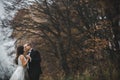 Happy bride and groom posing in the autumn forest Royalty Free Stock Photo