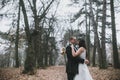 Happy bride and groom posing in the autumn forest Royalty Free Stock Photo