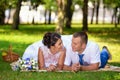 Happy bride and groom on their wedding lies on the grass in park Royalty Free Stock Photo