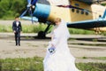 Happy bride and groom on their wedding near the old airplane Royalty Free Stock Photo