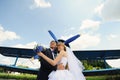 Happy bride and groom on their wedding. Old Airplane in background Royalty Free Stock Photo