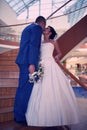 Happy bride and groom on their wedding stand on a wooden ladder Royalty Free Stock Photo