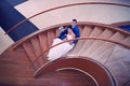 Happy bride and groom on their wedding stand on a wooden ladder Royalty Free Stock Photo