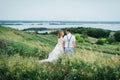 Happy Bride and groom walking on the green grass Royalty Free Stock Photo