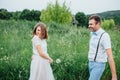 Happy Bride and groom walking on the green grass Royalty Free Stock Photo