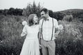 Happy Bride and groom walking on the green grass Royalty Free Stock Photo