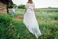 Happy Bride and groom walking on the green grass Royalty Free Stock Photo