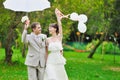 Happy bride and groom walking together in a park Royalty Free Stock Photo