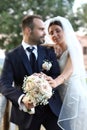 Happy bride and groom in wedding day. Wedding couple in love, newlyweds. Wedding concept. wedding bouquet in the foreground Royalty Free Stock Photo