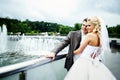 Happy bride and groom at wedding walk on bridge