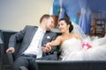 Happy bride and groom on the wedding walk in the modern hotel hall Royalty Free Stock Photo