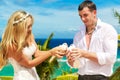 The happy bride and groom with white doves on a tropical beach u Royalty Free Stock Photo