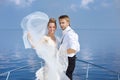 Happy bride and groom on a yacht Royalty Free Stock Photo