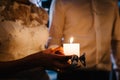 Happy bride hold and groom keep a family candle burning on the wedding day after the ceremony. the end of the wedding and the Royalty Free Stock Photo
