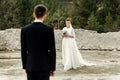 Happy bride looking at her groom at sandy lake, luxury elegant wedding Royalty Free Stock Photo