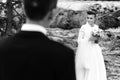 Happy bride looking at her groom at sandy lake, luxury elegant wedding, black and white Royalty Free Stock Photo