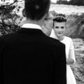 Happy bride looking at her groom at sandy lake, luxury elegant wedding, black and white Royalty Free Stock Photo