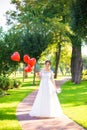 Happy bride and red ballons