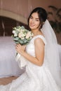Happy bride sit in wedding dress and smiled. Bridde with bouquet Royalty Free Stock Photo