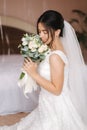 Happy bride sit in wedding dress and smiled. Bridde with bouquet Royalty Free Stock Photo