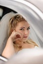 Happy bride sitting in the wedding car Royalty Free Stock Photo