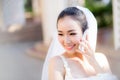 Happy bride talking on cell phone in wedding dress Royalty Free Stock Photo