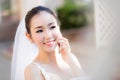 Happy bride talking on cell phone in wedding dress Royalty Free Stock Photo