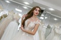 Happy bride tries on a wedding dress in salon Royalty Free Stock Photo