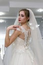 Happy bride tries on a wedding dress in salon Royalty Free Stock Photo