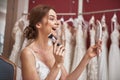 Happy bride in wedding dress doing make-up Royalty Free Stock Photo