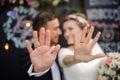 Happy bridegroom and bride showing wedding rings on their fingers