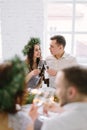 Happy bridesmaid and groomman at the wedding table drink champagne. Group of people sitting at wedding table in the
