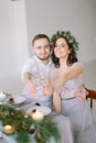 Happy bridesmaid and groomman at the wedding table drink champagne. Group of people sitting at wedding table in the