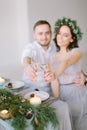 Happy bridesmaid and groomman at the wedding table drink champagne. Group of people sitting at wedding table in the