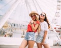 Happy brightful positive moments of two stylish girls hugging on street in city. Closeup portrait funny joyful attarctive young wo Royalty Free Stock Photo