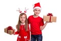Happy brother with santa hat on his head and a sister with deer horns, holding the gift boxes in their hands. Concept