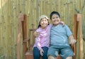 Happy Brother and sister smile and sit on swing Royalty Free Stock Photo