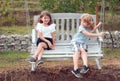 Happy brother and sister swinging on swing in summer park outdoors. Little boy and girl kids enjoying summer. Kids Royalty Free Stock Photo