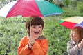 Happy brother with umbrella outdoors