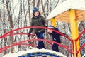 Happy brothers enjoing winter holidays. Kids on winter playground outdoors. Snowy day, cold winter weather. Winter outfit for kids Royalty Free Stock Photo