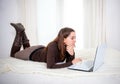 Happy brown hair latin woman working on her computer