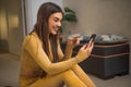 Excited caucasian young girl, pointing to phone screen, smiling Royalty Free Stock Photo