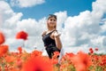 happy brunette lady enjoy freedom in the poppies field Royalty Free Stock Photo