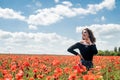 happy brunette lady enjoy freedom in the poppies field Royalty Free Stock Photo