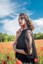 happy brunette lady enjoy freedom in the poppies field Royalty Free Stock Photo