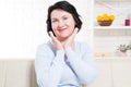 Happy brunette middle age woman at home. Skin care and anti aging concept. Selective focus