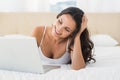 Happy brunette using her laptop Royalty Free Stock Photo