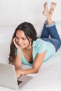 Happy brunette using her laptop Royalty Free Stock Photo